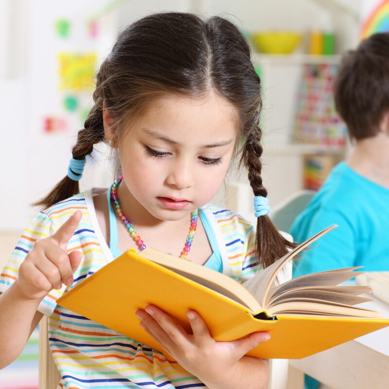 Child wearing a graduation cap